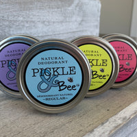 Image of four different types or scents of pickle and bee natural deodorants, each with a brightly coloured label